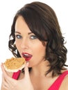 Young Woman Eating Peanut Butter on a Cracker Royalty Free Stock Photo