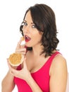 Young Woman Eating Peanut Butter on a Cracker Rice Cake