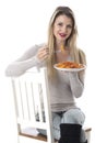 Young Woman Eating Penne Pasta