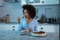 Young Woman Eating A Piece Of Cake At Night Royalty Free Stock Photo