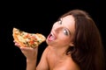 Young woman eating a piece of pizza Royalty Free Stock Photo