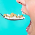 Young woman eating pills on a spoon Royalty Free Stock Photo