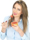 Young Woman Eating a Pink Grapefruit Royalty Free Stock Photo