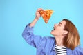 young woman eating pizza slice and looking delighted Royalty Free Stock Photo