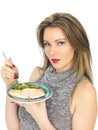 Young Woman Eating Poached Salmon and Salad Royalty Free Stock Photo
