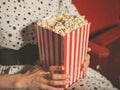 Young woman eating popcorn in movie theater Royalty Free Stock Photo