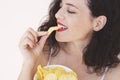 Young woman eating potato chips out of a bowl Royalty Free Stock Photo