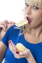 Young Woman Eating Potato Crisps Royalty Free Stock Photo
