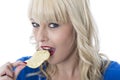 Young Woman Eating Potato Crisps Royalty Free Stock Photo