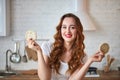 Young woman eating rye cracker crisp bread in the kitchen. Healthy Lifestyle. Health, Beauty, Diet Concept Royalty Free Stock Photo