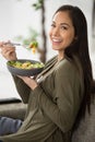 young woman eating salad