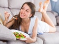 Young woman is eating salad because she being on vegetable diet Royalty Free Stock Photo