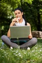 Young woman eating sandwitch in park Royalty Free Stock Photo