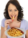 Young Woman Eating Saveloy and Chips Royalty Free Stock Photo