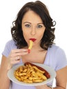 Young Woman Eating Saveloy and Chips Royalty Free Stock Photo