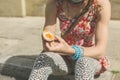 Young woman eating scotch egg in the street Royalty Free Stock Photo