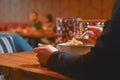 Young woman eating soup served in a white bowl. Eating out. Restaurant concept. Woman` s hand holding spoon. Royalty Free Stock Photo