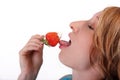 Young woman eating strawberry Royalty Free Stock Photo