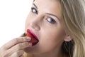 Young Woman Eating a Strawberry Royalty Free Stock Photo