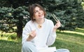 A young woman eating sushi in the park, picnic in nature. Royalty Free Stock Photo