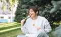 A young woman eating sushi in the park, picnic in nature. Royalty Free Stock Photo