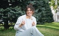 A young woman eating sushi in the park, picnic in nature. Royalty Free Stock Photo