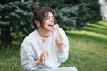 A young woman eating sushi in the park, picnic in nature. Royalty Free Stock Photo