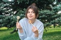 A young woman eating sushi in the park, picnic in nature. Royalty Free Stock Photo