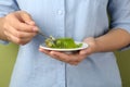 Young woman eating tasty kiwi jelly on background, closeup Royalty Free Stock Photo