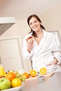 Young woman eating toast for breakfast in kitchen Royalty Free Stock Photo