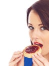 Young Woman Eating Toasted Crumpet and Jam Royalty Free Stock Photo