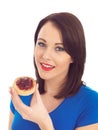 Young Woman Eating Toasted Crumpet and Jam Royalty Free Stock Photo