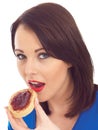 Young Woman Eating Toasted Crumpet and Jam Royalty Free Stock Photo