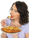 Young Woman Eating Traditional Fish and Chips Royalty Free Stock Photo