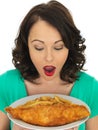 Young Woman Eating Traditional Fish and Chips Royalty Free Stock Photo