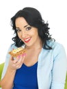 Young Woman Eating a Wholegrain Cracker with Peanut Butter and Sliced Banana