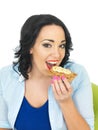 Young Woman Eating a Wholegrain Cracker with Peanut Butter and Sliced Banana