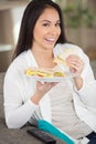 Young woman eating wholesome sandwich Royalty Free Stock Photo