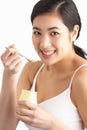 Young Woman Eating Yoghurt In Studio Royalty Free Stock Photo