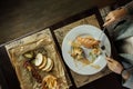 Young woman eats salmon fillet and fish tartare at an elegantly laid table in a restaurant. Health food. Top view