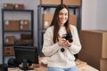 Young woman ecommerce business worker holding professional camera at office Royalty Free Stock Photo