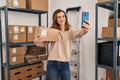 Young woman ecommerce business worker make selfie by the smartphone at office Royalty Free Stock Photo