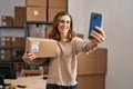 Young woman ecommerce business worker make selfie by the smartphone at office Royalty Free Stock Photo
