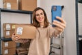 Young woman ecommerce business worker make selfie by the smartphone at office Royalty Free Stock Photo