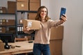 Young woman ecommerce business worker make selfie by the smartphone at office Royalty Free Stock Photo