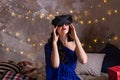 The young woman in ecstasy sits in helmet for a virtual reality Royalty Free Stock Photo