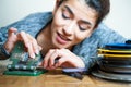 Young woman editing 8 mm movie reel film