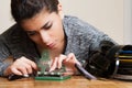 Young woman editing super 8 mm movie reel film