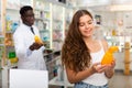 Young woman electing haircare shampoo