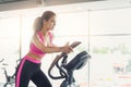 Young woman on elliptical trainer